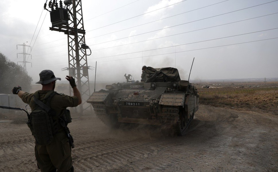 epa10918417 Israeli troops muster at a gathering site at an undisclosed location along the borderline with Gaza, 14 October 2023. The Israeli Defense Force (IDF) on 13 October had called for the evacuation of all civilians of northern Gaza ahead of an exp