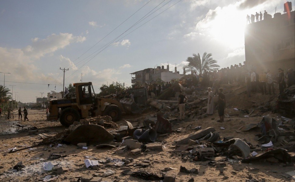 epa10921472 Palestinians search for bodies and survivors in the rubble of a residential building leveled in an Israeli airstrike, in Khan Younis refugee camp in the southern Gaza Strip, on 16 October 2023  Israel has called for the evacuation of all civil