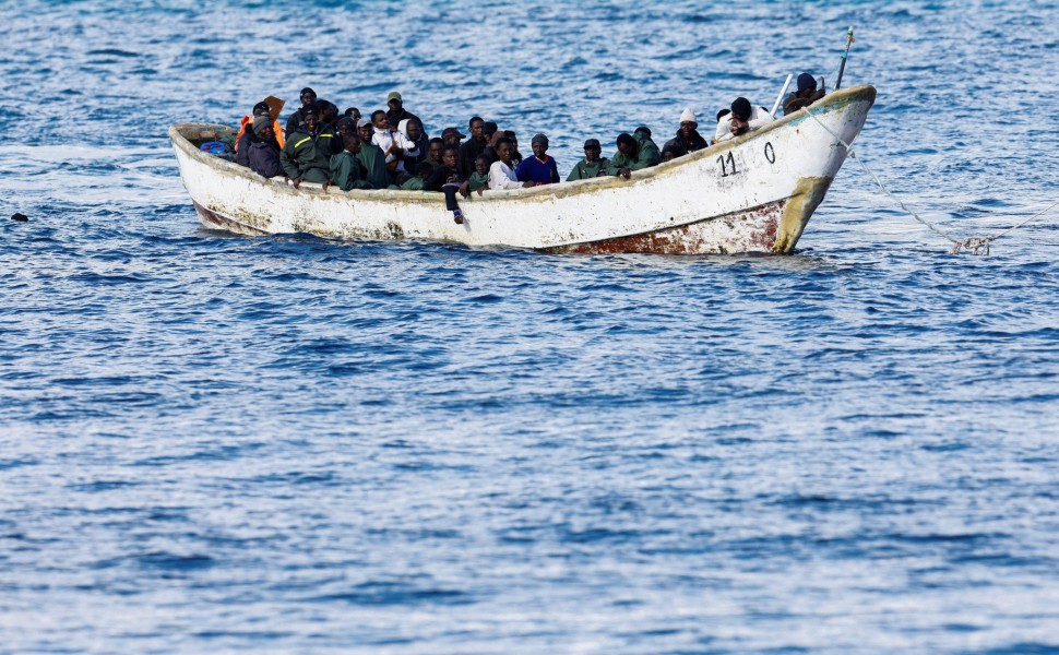 Reuters - A Spanish Coast Guard vessel tows a fibreglass boat with migrants onboard to the port of Arguineguin, on the island of Gran Canaria.